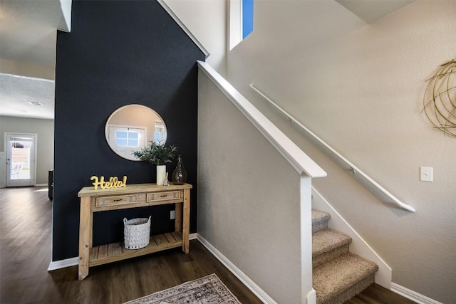 stairway with baseboards and wood finished floors