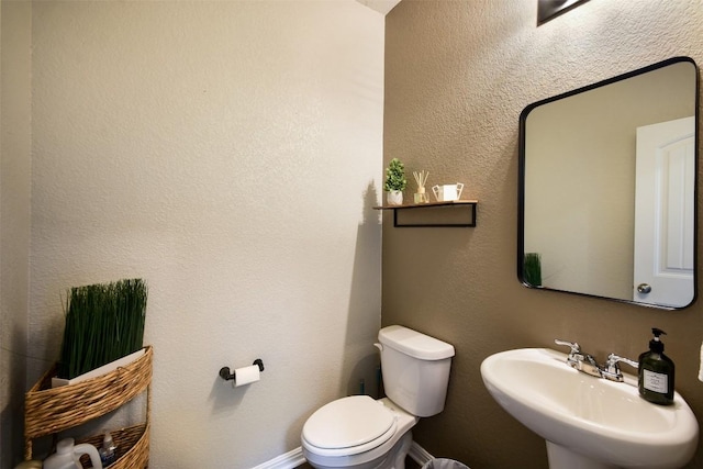 half bathroom with a sink and toilet
