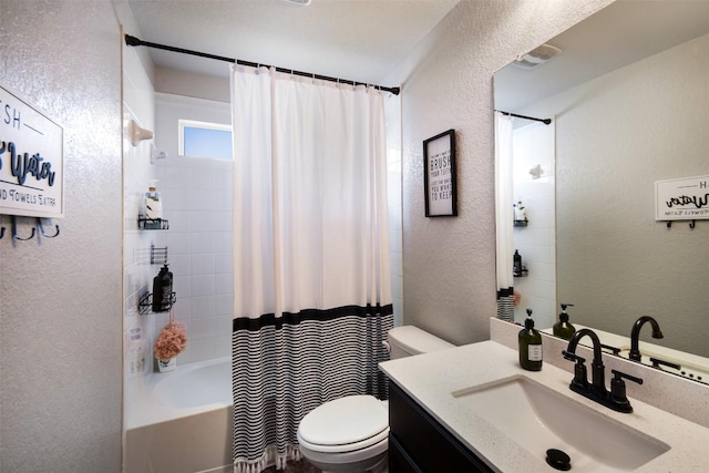 bathroom featuring toilet, a textured wall, shower / bathtub combination with curtain, and vanity