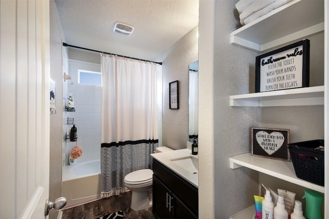 217 Frederick Dr, Georgetown, TX 78626 - full bathroom featuring a textured wall, vanity, wood finished floors, shower / bath combo with shower curtain, and a textured ceiling