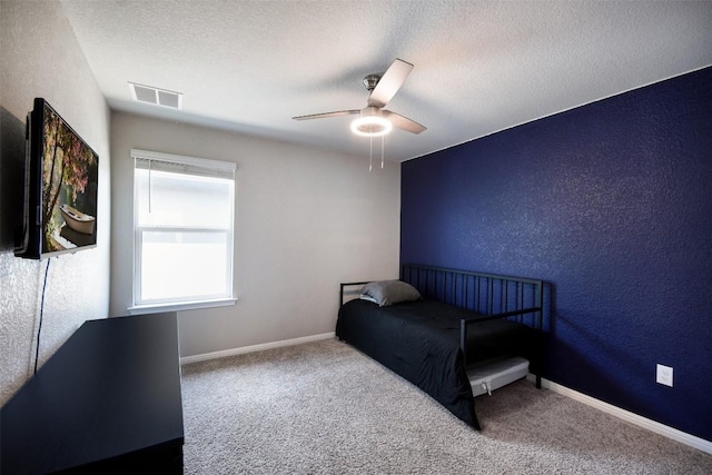 217 Frederick Dr, Georgetown, TX 78626 - unfurnished bedroom with carpet floors, a ceiling fan, a textured wall, and a textured ceiling