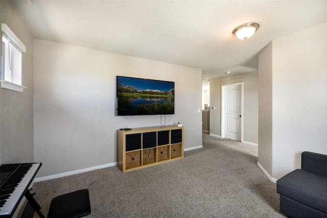 carpeted living room with baseboards
