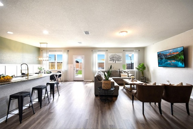 217 Frederick Dr, Georgetown, TX 78626 - living area featuring a textured ceiling, wood finished floors, and recessed lighting