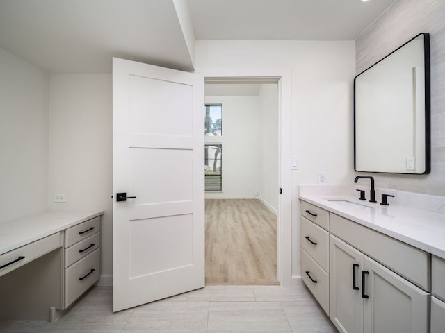 bathroom featuring vanity and baseboards
