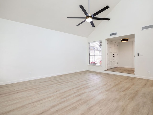 unfurnished living room featuring visible vents, baseboards, light wood finished floors, and high vaulted ceiling