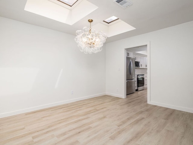 unfurnished room featuring visible vents, baseboards, a chandelier, light wood-style flooring, and a skylight