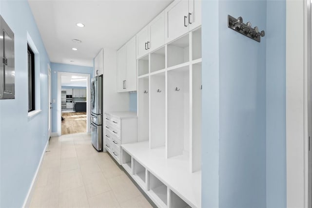 mudroom with baseboards and recessed lighting