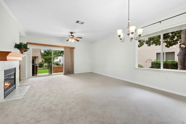 508 Texas Dr, Georgetown, TX 78633 - unfurnished living room with crown molding, light colored carpet, a tiled fireplace, ceiling fan with notable chandelier, and visible vents