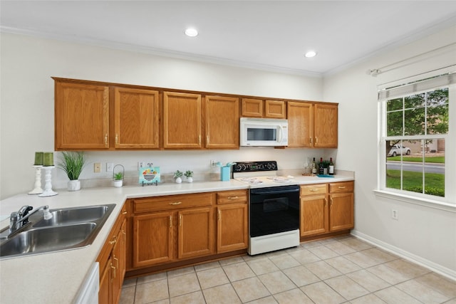 508 Texas Dr, Georgetown, TX 78633 - kitchen featuring brown cabinetry, a sink, light tile patterned floors, and white appliances