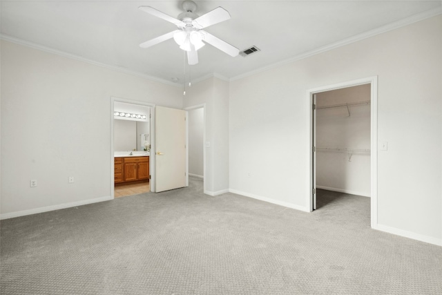 508 Texas Dr, Georgetown, TX 78633 - unfurnished bedroom with light colored carpet, visible vents, ornamental molding, and a spacious closet