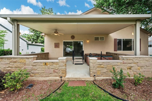 508 Texas Dr, Georgetown, TX 78633 - rear view of house featuring a ceiling fan, a patio area, stone siding, and stucco siding