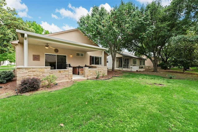508 Texas Dr, Georgetown, TX 78633 - rear view of house featuring a ceiling fan, stucco siding, a yard, and stone siding