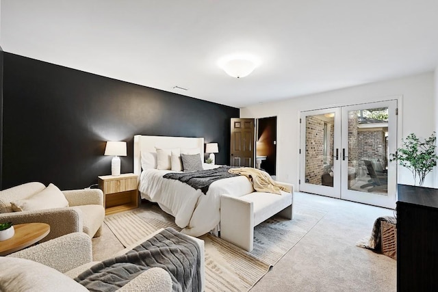 carpeted bedroom with french doors, visible vents, and access to exterior