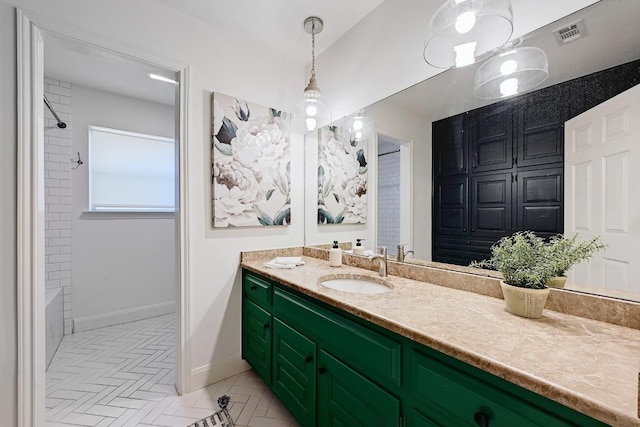 bathroom featuring baseboards, vanity, and visible vents