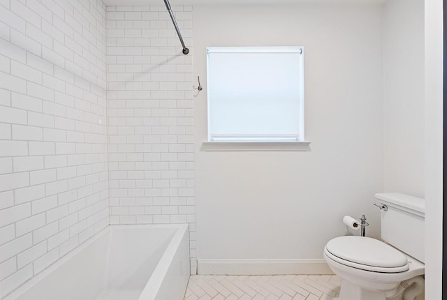 full bath with toilet, baseboards, bathing tub / shower combination, and tile patterned flooring