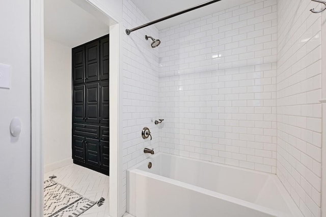bathroom with shower / bath combination and baseboards