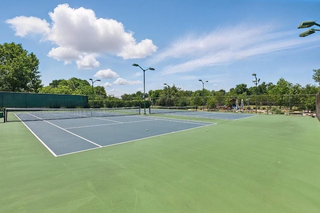 view of sport court featuring fence