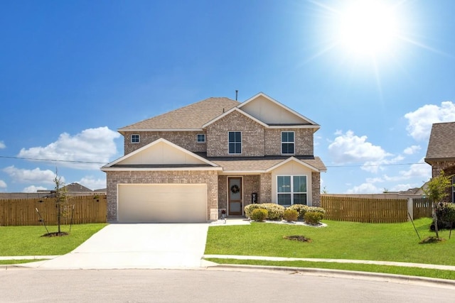 traditional home featuring concrete driveway, brick siding, an attached garage, and fence