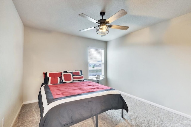 carpeted bedroom with a ceiling fan and baseboards