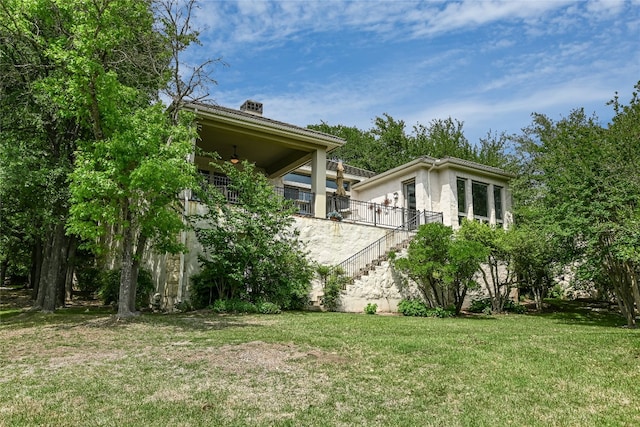 2305 Barton Creek Blvd Unit 28, Austin, TX 78735 - view of home's exterior with a lawn and stairway
