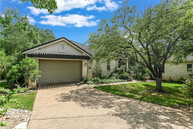 2305 Barton Creek Blvd Unit 28, Austin, TX 78735 - view of front of house with stucco siding, an attached garage, driveway, and a front yard