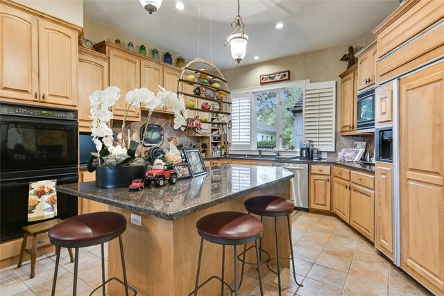 2305 Barton Creek Blvd Unit 28, Austin, TX 78735 - kitchen featuring a center island, recessed lighting, built in appliances, and a breakfast bar area