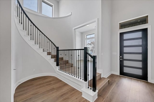 1400 Mulberry Oak Ln, Georgetown, TX 78628 - foyer with a high ceiling, wood finished floors, stairway, and baseboards