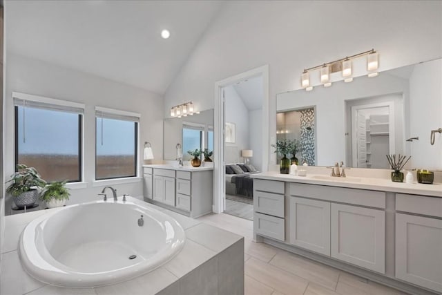 1400 Mulberry Oak Ln, Georgetown, TX 78628 - bathroom featuring two vanities, a bath, a walk in closet, tile patterned floors, and recessed lighting