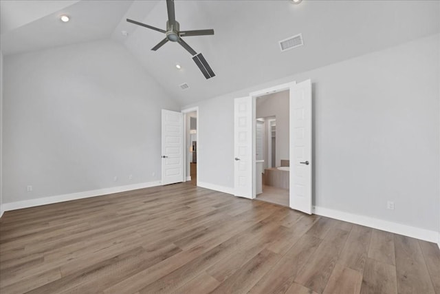 1400 Mulberry Oak Ln, Georgetown, TX 78628 - unfurnished bedroom with wood finished floors, high vaulted ceiling, baseboards, ensuite bathroom, and recessed lighting