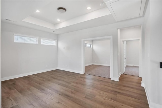 1400 Mulberry Oak Ln, Georgetown, TX 78628 - empty room with attic access, wood finished floors, baseboards, recessed lighting, and a tray ceiling