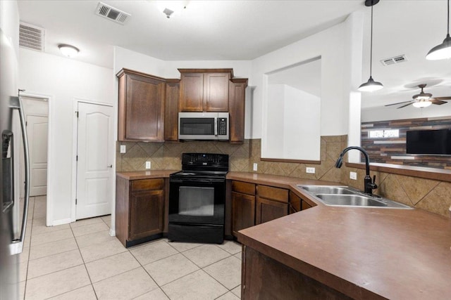 kitchen featuring stainless steel appliances, visible vents, and a sink