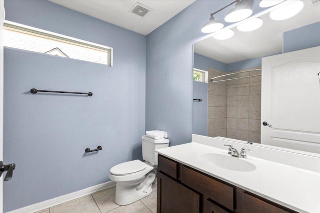 full bathroom with visible vents, vanity, toilet, walk in shower, and tile patterned floors