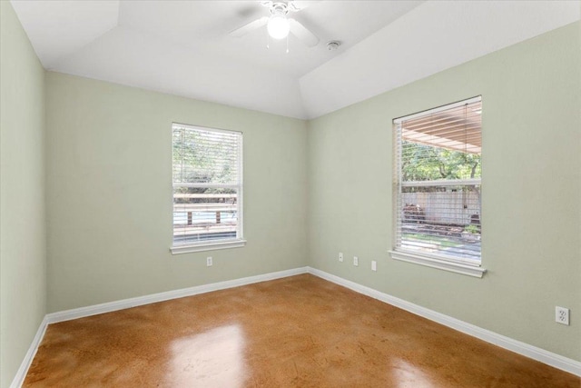 empty room with baseboards, ceiling fan, and lofted ceiling