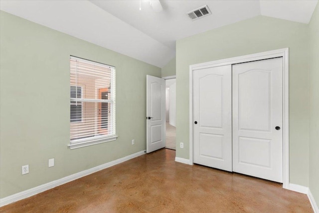 unfurnished bedroom featuring baseboards, visible vents, vaulted ceiling, and a closet