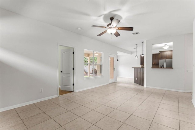 unfurnished living room with a ceiling fan, baseboards, visible vents, and light tile patterned floors