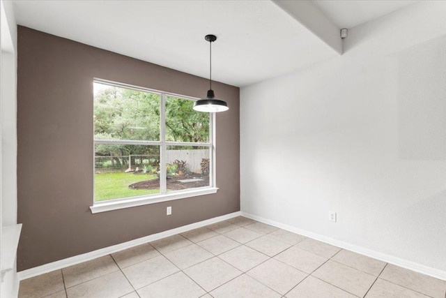 unfurnished dining area with baseboards and light tile patterned floors