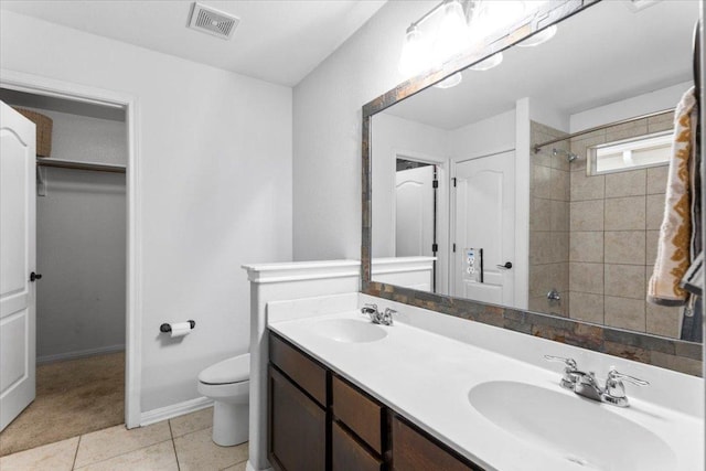 bathroom with visible vents, a sink, walk in shower, and toilet