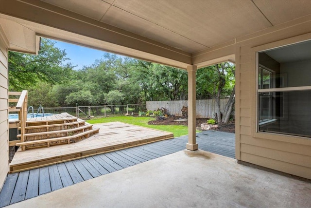 view of patio featuring a deck and a fenced backyard