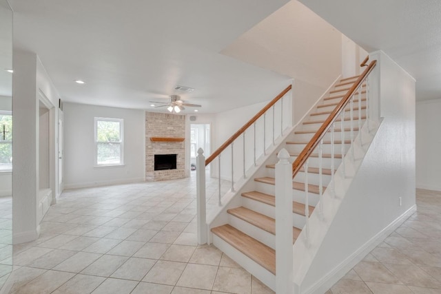 15203 Dormax Cir, Leander, TX 78641 - staircase with a fireplace, ceiling fan, tile patterned floors, baseboards, and recessed lighting