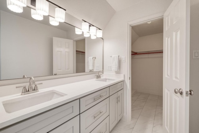 15203 Dormax Cir, Leander, TX 78641 - full bath with marble finish floors, double vanity, a walk in closet, and lofted ceiling