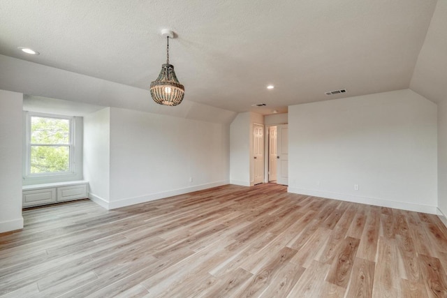 15203 Dormax Cir, Leander, TX 78641 - empty room featuring vaulted ceiling, light wood finished floors, baseboards, and recessed lighting