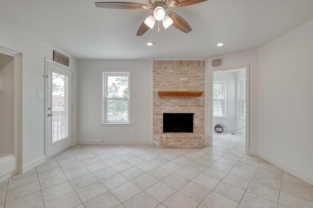 15203 Dormax Cir, Leander, TX 78641 - unfurnished living room featuring light tile patterned floors, a brick fireplace, a ceiling fan, baseboards, and recessed lighting