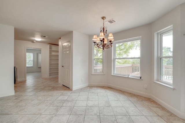 15203 Dormax Cir, Leander, TX 78641 - spare room with plenty of natural light, a chandelier, and light tile patterned floors