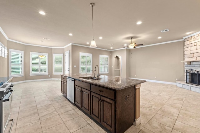 kitchen featuring visible vents, a stone fireplace, open floor plan, a sink, and appliances with stainless steel finishes