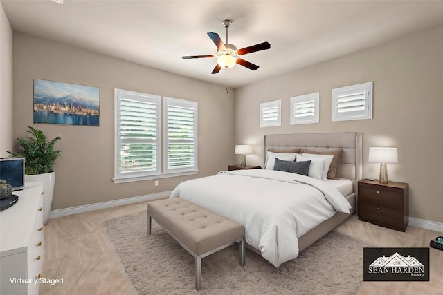 bedroom featuring baseboards, ceiling fan, and light colored carpet