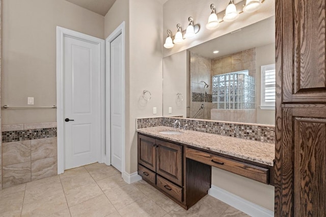 bathroom featuring walk in shower, tile patterned flooring, and vanity