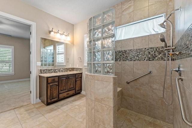 bathroom with a healthy amount of sunlight, a walk in shower, and vanity