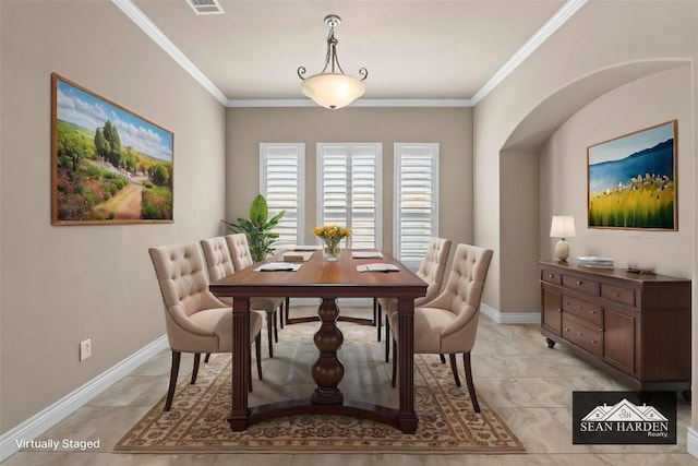 dining room with baseboards, visible vents, and ornamental molding