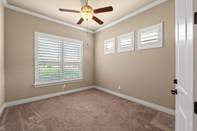 carpeted spare room with crown molding, baseboards, and ceiling fan
