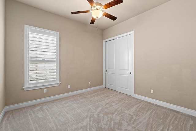unfurnished bedroom featuring carpet floors and baseboards